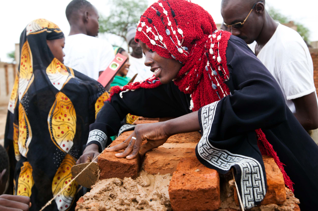 Woman bricks - previous newsletter Woman laying bricks