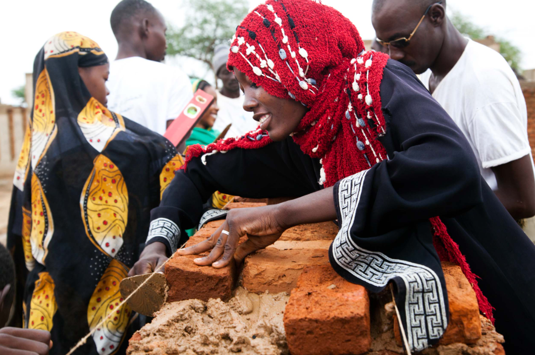 Woman laying bricks